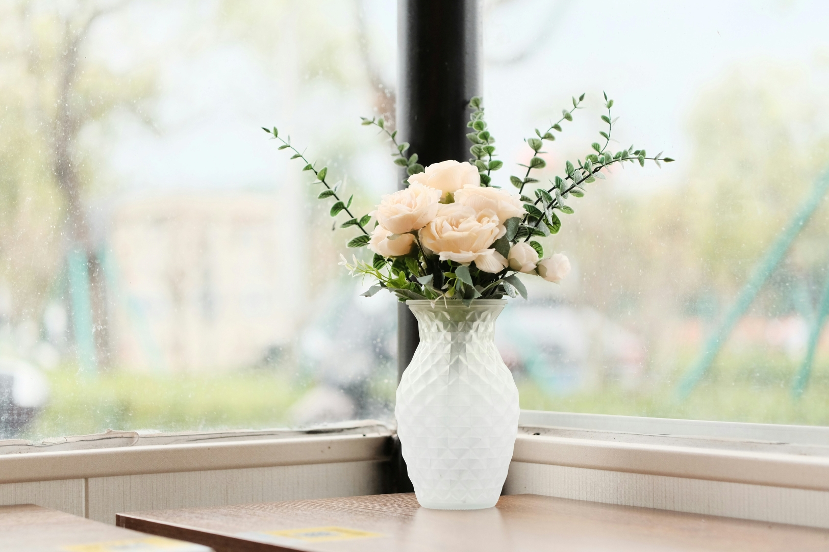 A vase of flowers on a windowsill