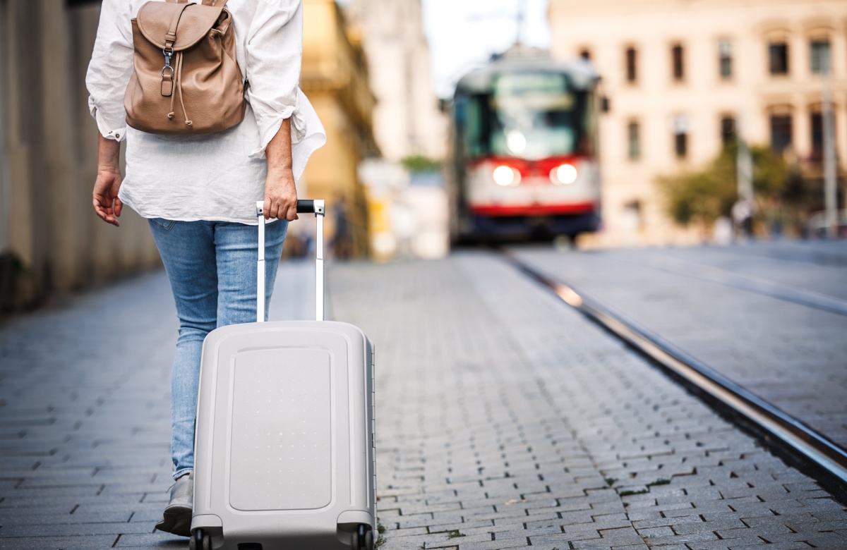 A solo female traveller with a suitcase