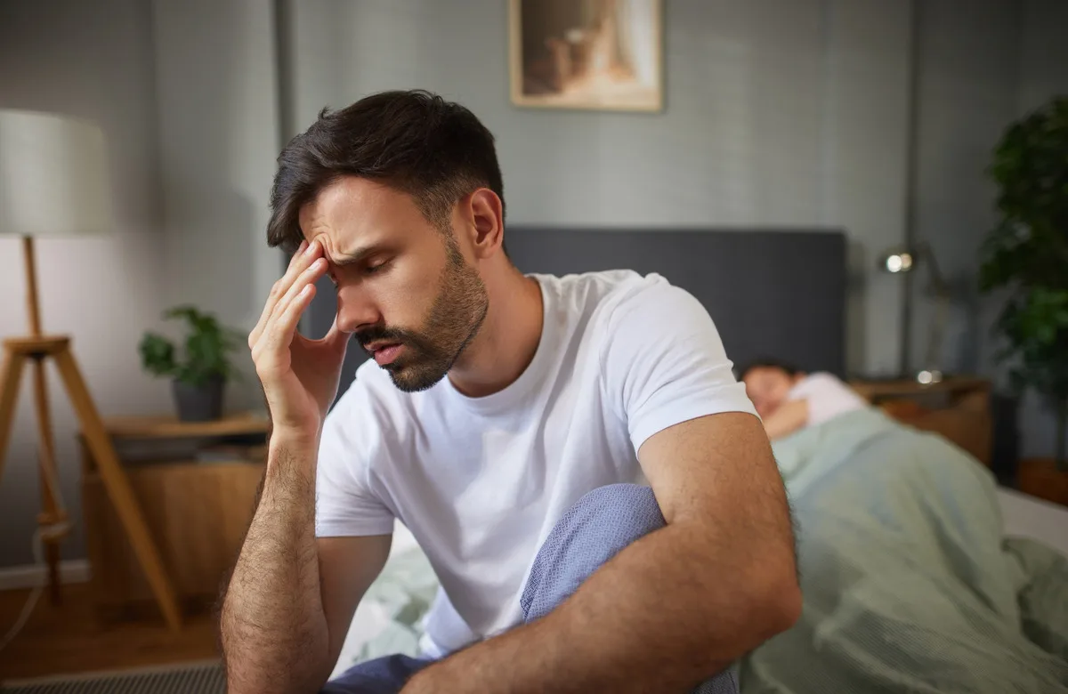 A man struggling to sleep.